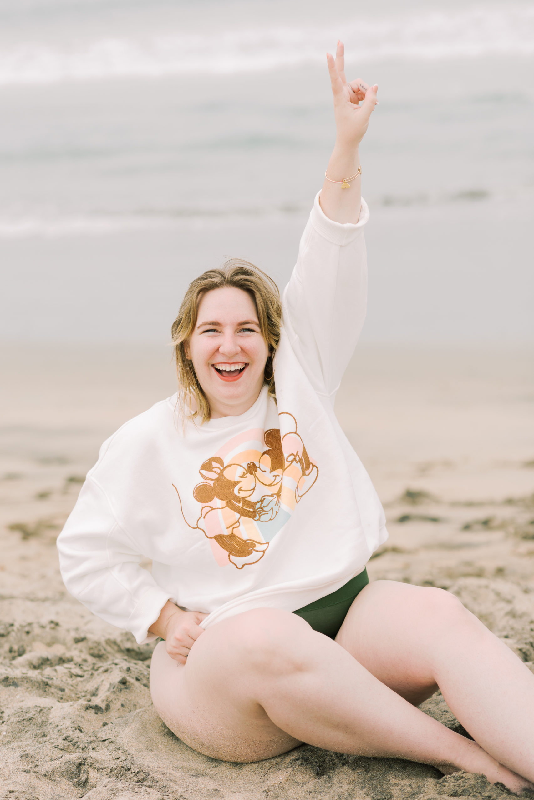 young woman sitting on beach - lifestyle blog title 100 things i desire